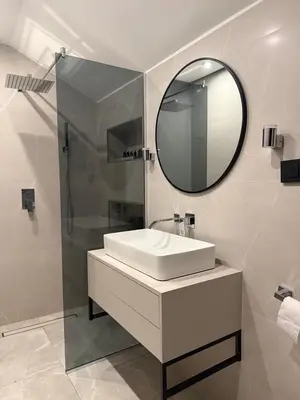 a bathroom with a sink and a mirror at Valmont Luxury Chalet in Glozhene