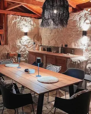 a large wooden table in a room with chairs at Valmont Luxury Chalet in Glozhene