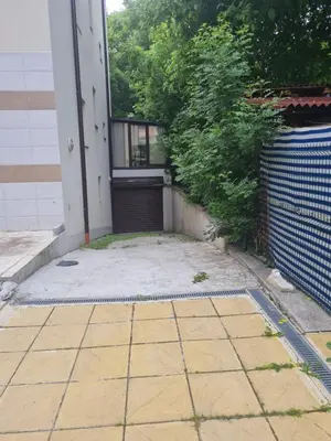 an outside view of a house with a garage at Cozy apartment with balcony in Sofia