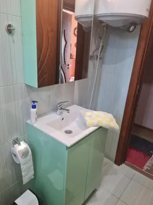 a bathroom with a sink and a mirror at Cozy apartment with balcony in Sofia