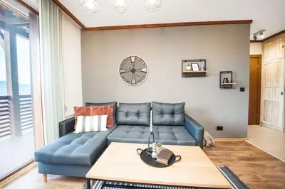 a living room with a blue couch and a table at Bansko Best View Apartment in Bansko