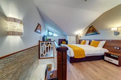 a bedroom with a king sized bed in a attic at OAK PARADISE in Smolyan