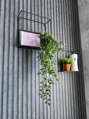 a wall with a shelf with plants on it at Luxury Apartment/Studio in Plovdiv