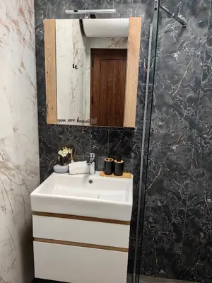 a bathroom with a white sink and a mirror at Luxury Apartment/Studio in Plovdiv
