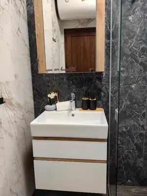 a bathroom with a white sink and a mirror at Luxury Apartment/Studio in Plovdiv