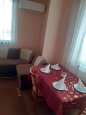 a living room with a table with a red table cloth at Apartment Ceco in Troyan