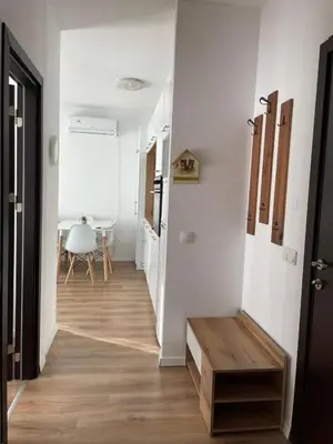a hallway with white walls and a wooden floor at Charming comfortable apartment at Cornelia Deluxe Residence with free pool and SPA in Razlog