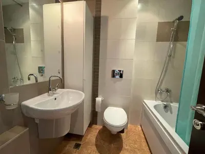 a bathroom with a sink and a toilet and a tub at Charming comfortable apartment at Cornelia Deluxe Residence with free pool and SPA in Razlog