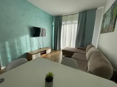 a living room with a couch and a table at Charming comfortable apartment at Cornelia Deluxe Residence with free pool and SPA in Razlog