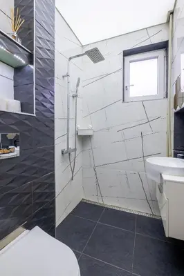 a bathroom with a shower and a toilet and a sink at Modern , spacious 2BR apartment in top center in Sofia