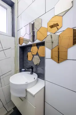 a bathroom with a sink and a mirror at Modern , spacious 2BR apartment in top center in Sofia