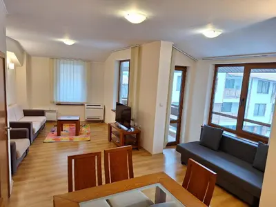 a living room with a couch and a table at SNOW PEAK TODORKA AND VIHREN APARTAMENT /NEXT TO THE LIFT/ 7 PERSONS/ in Bansko