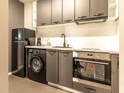 a kitchen with a sink and a dishwasher at Trocadero Touch: Sofia Hideaway in Sofia
