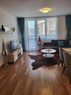 a living room with a couch and a table at Beautiful Apartment in Bansko