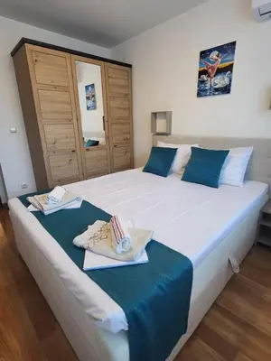 a bedroom with a large bed with towels on it at Beautiful Apartment in Bansko