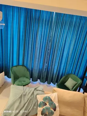 two green chairs in a room with blue curtains at Апартамент ВалАнди in Samokov