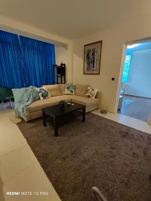 a living room with a couch and a table at Апартамент ВалАнди in Samokov