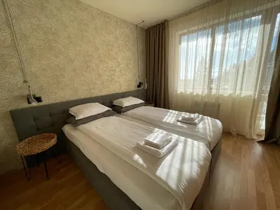 a bedroom with a large bed with towels on it at LHApartment! in Pamporovo