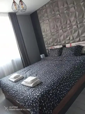 a bedroom with a bed with two towels on it at Royal Park Bansko premium in Bansko