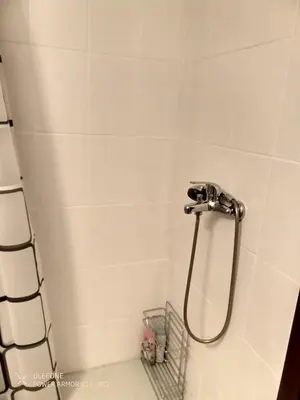 a shower with a hose in a bathroom at Royal Park Bansko premium in Bansko