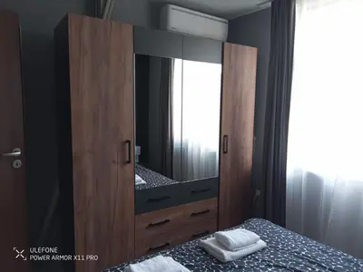 a bedroom with a large wooden cabinet with a mirror at Royal Park Bansko premium in Bansko