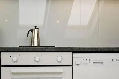 a kitchen with white appliances and a sink at Lofty - 1 bedroom apartment in the heart of Sofia in Sofia