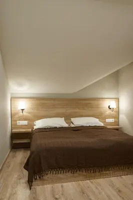 a bedroom with a large bed with two lamps at Lofty - 1 bedroom apartment in the heart of Sofia in Sofia