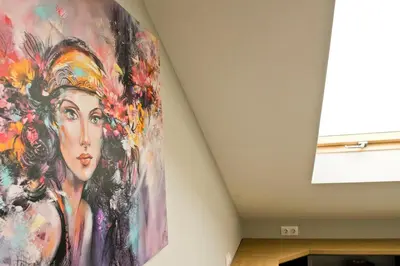 a large painting of a woman on a wall at Lofty - 1 bedroom apartment in the heart of Sofia in Sofia