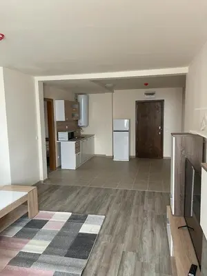 an empty room with a kitchen with a refrigerator at Bron's Suite in Pamporovo
