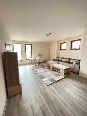 a living room with a couch and a table at Bron's Suite in Pamporovo