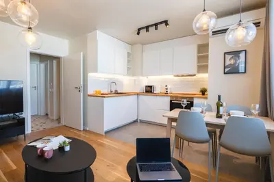 a kitchen and living room with a laptop on a table at Design 1BDR Apartment near City Center in Sofia