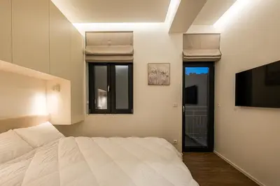 a bedroom with a white bed and a tv at South 22 - Brand New Modern 1BD Apt in Sofia Center by Flat Mаnager in Sofia