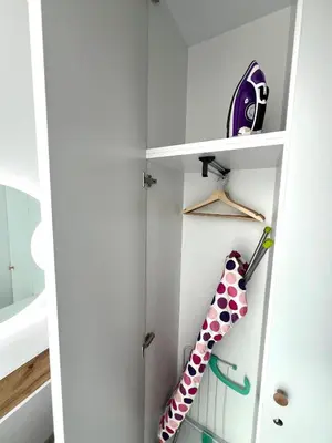 a shelf with a polka dot umbrella in a room at Stracciatella Homes Apartment in Sofia