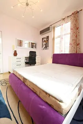 a bedroom with a large bed with a purple mattress at INB Iconic Spot in Sofia