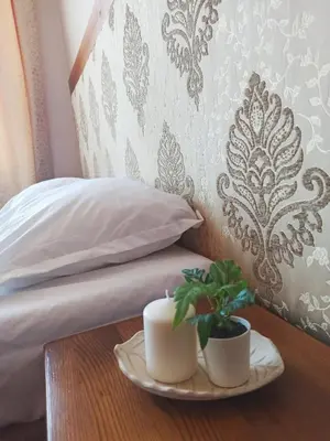 a table with a candle and a plant on a bed at Sunrise View with Free SPA and Bottle of Wine in Cornelia Deluxe Residence, free Parking in Bansko