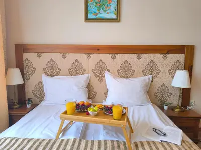 a bed with a tray of fruit and drinks on it at Sunrise View with Free SPA and Bottle of Wine in Cornelia Deluxe Residence, free Parking in Bansko