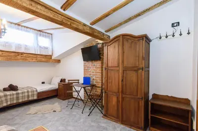 a bedroom with a bed and a large wooden cabinet at Chalet Garibaldi - Total Chalets in Bansko