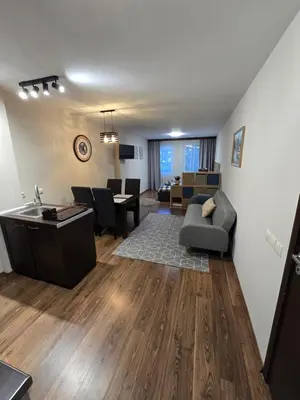 a living room with a couch and a table at IG Apartments Royal Towers 426 in Bansko