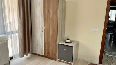 a room with a wooden cabinet next to a door at Къща за гости Михаела in Chepelare