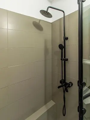 a shower with a shower head in a bathroom at Lion's Bridge Haven - Sofia Central Studio in Sofia
