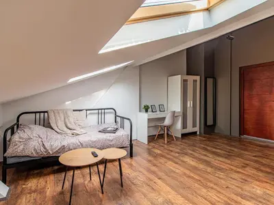 a bedroom with a bed and two tables at Lion's Bridge Haven - Sofia Central Studio in Sofia
