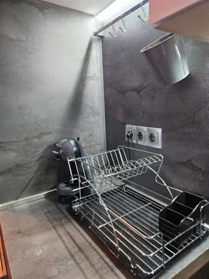 a kitchen with a dish drying rack on the oven at Стаята на Ив in Bansko