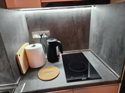 a kitchen counter with a coffee maker on a counter top at Стаята на Ив in Bansko