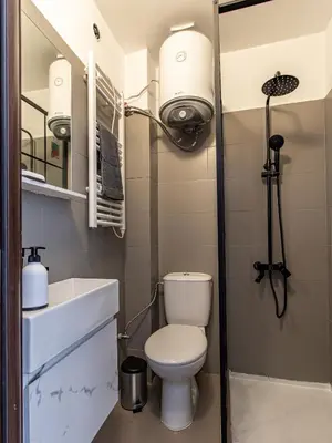 a small bathroom with a toilet and a sink at Vitosha Loft - Central Sofia Studio in Sofia