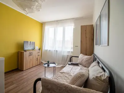 a living room with a couch and a table at Serdika Loft - Central Sofia Studio in Sofia