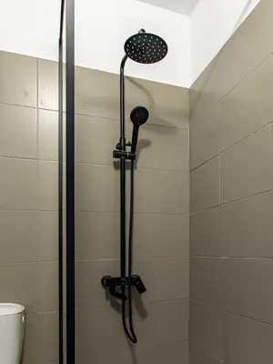 a shower with a shower head in a bathroom at Serdika Loft - Central Sofia Studio in Sofia