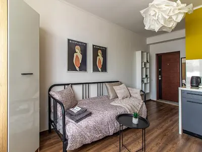 a living room with a bed and a table at Serdika Loft - Central Sofia Studio in Sofia