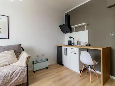 a small apartment with a kitchen and a couch at Largo Loft - Central Sofia Studio in Sofia