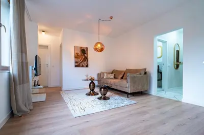 a living room with a couch and a table at Didi's Central Designer Apartments in Sofia