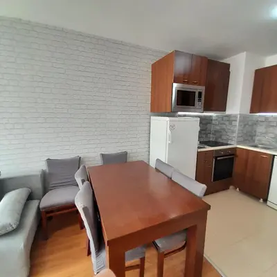 a kitchen and dining room with a table and a couch at lux Apartament L201 in Bansko
